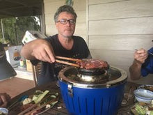 Load image into Gallery viewer, Cooking protein over an asian Fondue, on LotusGrill Fondue Set