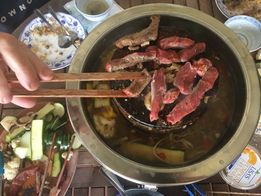 Overhead image of protein cooked on the grill within the LotusGrill Fondue Set